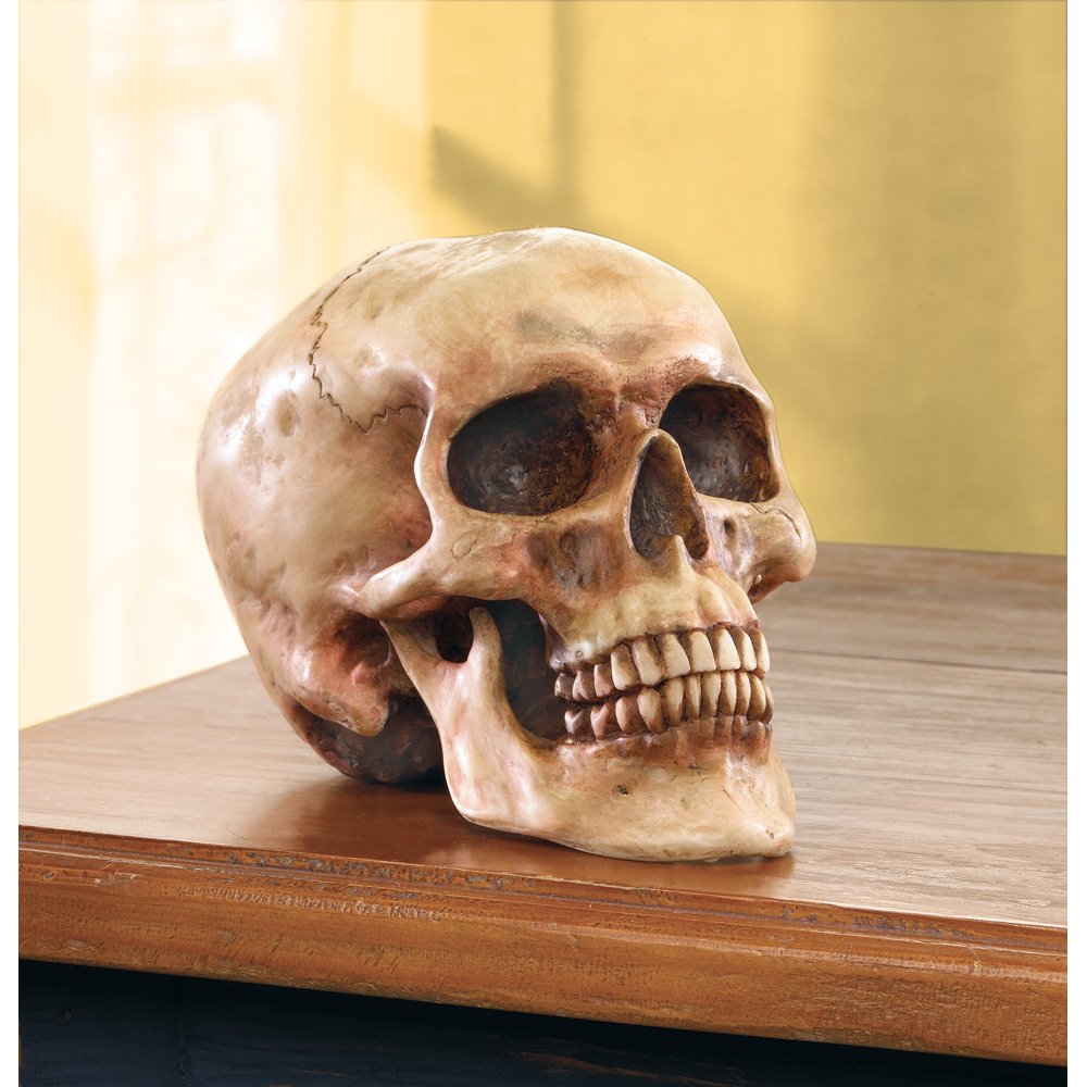 Grinning skull figurine